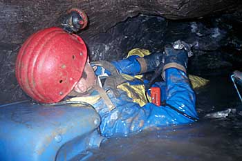 Peter lays down in the sump, drilling holes with the Bosch drill